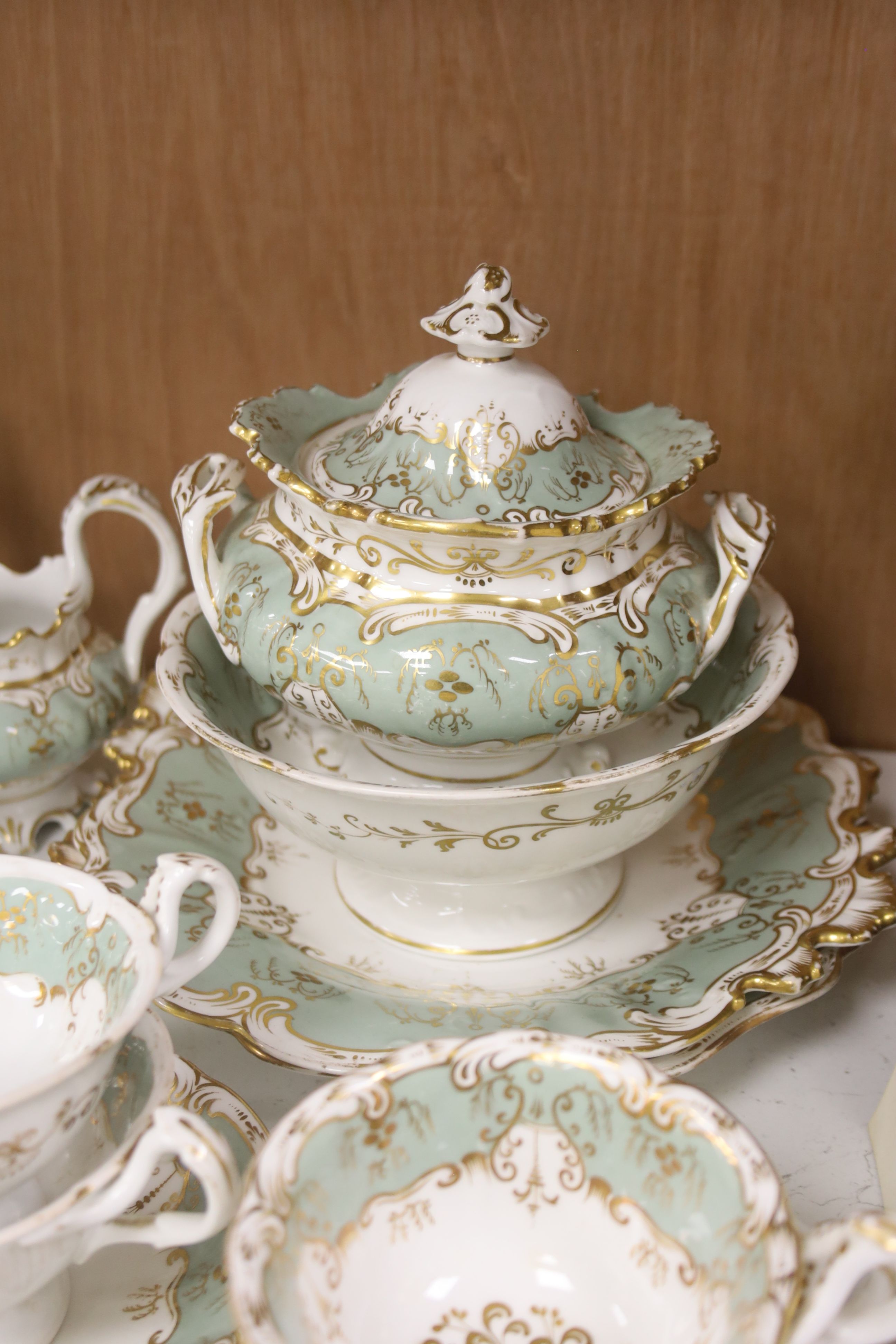 An English porcelain eau-de-nil gilt decorated tea service, c.1840